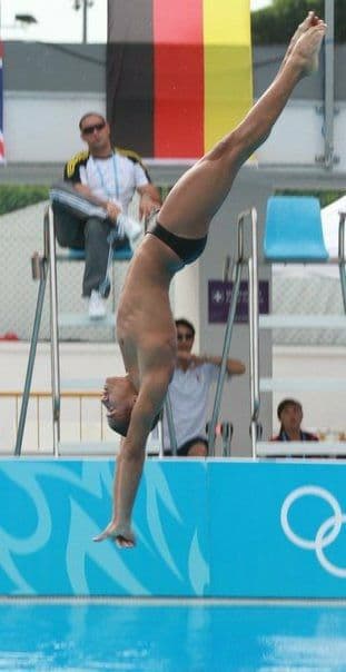 Diver Robert Paez competing with Coach Ilich Marcano visible in the background